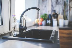 Large sink with water running out of tap.