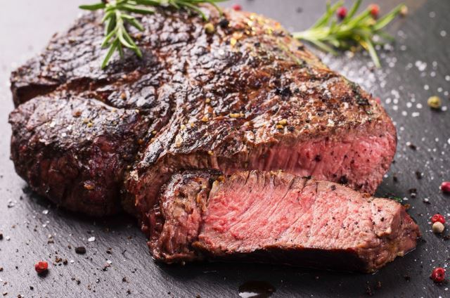 Juicy Steak Juicy Steak image surrounded by peppercorns and thyme.