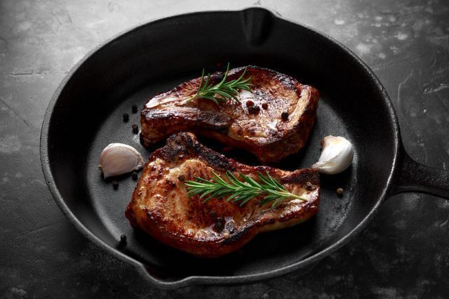 Skillet Pork Chops Skillet Pork Chops in skillet with garlic and thyme.