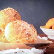 Baked pretzel bread on a wooden platter.