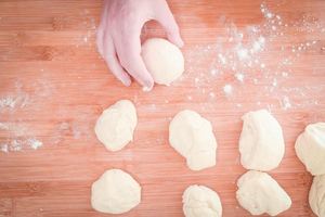 Rolling dough pieces into balls.