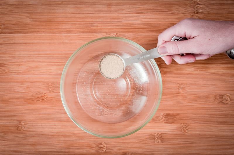How to Make Pretzel Bread Step 2 Adding sugar to water in a bowl.