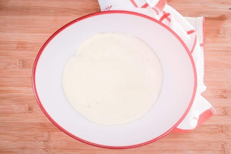 How to Make Pretzel Bread Step 10-3 Pretzel roll dough in a bowl.