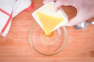 Pouring melted butter into bowl.