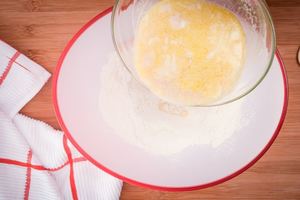 Pouring yeast mix into flour.