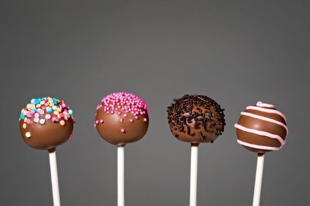 multiple cake pop types 4 cake pops in a row.