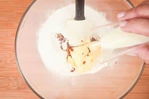 Adding vanilla to sugar and butter.