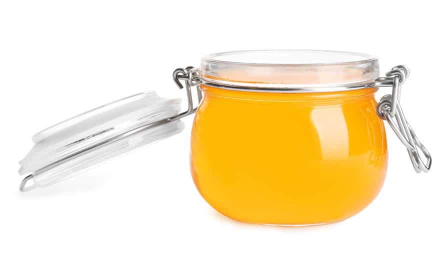 Clear jelly in a jar. Clear jelly in a jar, white background.