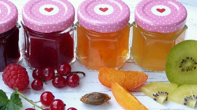 jams and jellies Jams and jellies in a row, surrounded by fresh fruits.