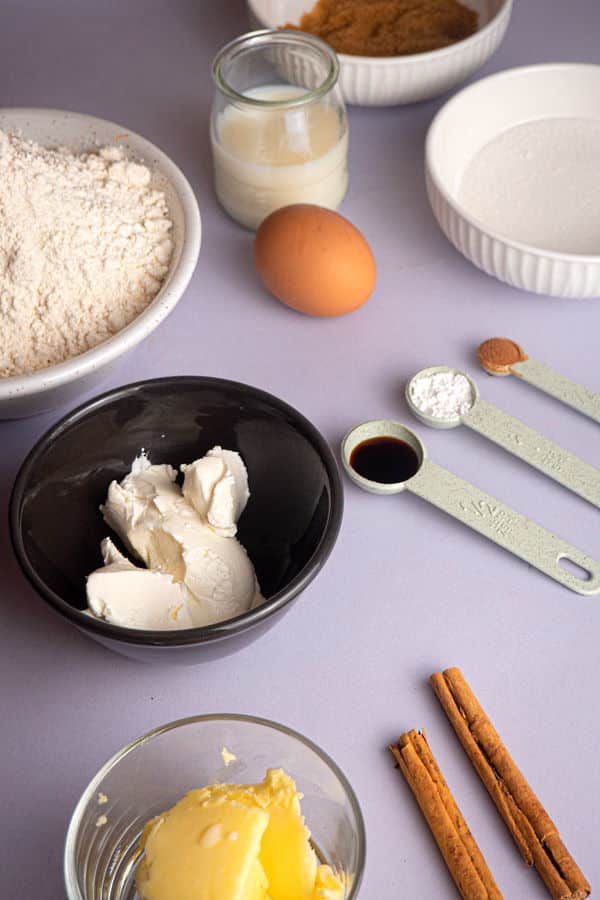 How to Make Cinnamon Rolls_1 Cinnamon bun ingredients prepped on white background.