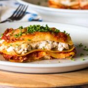 Piece of lasagna on a plate.