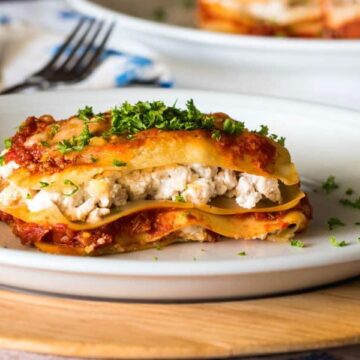Piece of lasagna on a plate.