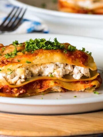Piece of lasagna on a plate.