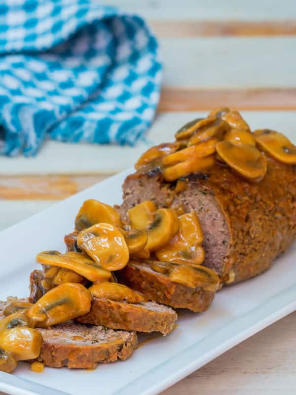 Electric Skillet Meatloaf 2 - IntheKitch Meatloaf covered in a mushroom sauce on a serving dish.
