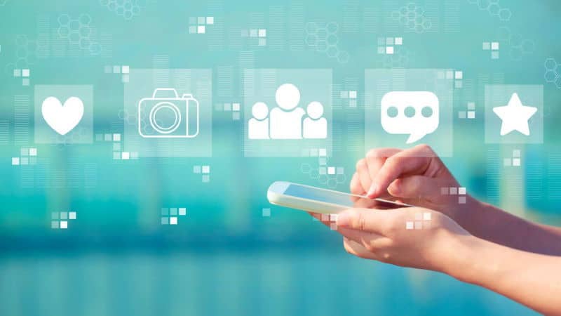 Social media with person holding a white smartphone Social media with person holding a white smartphone
