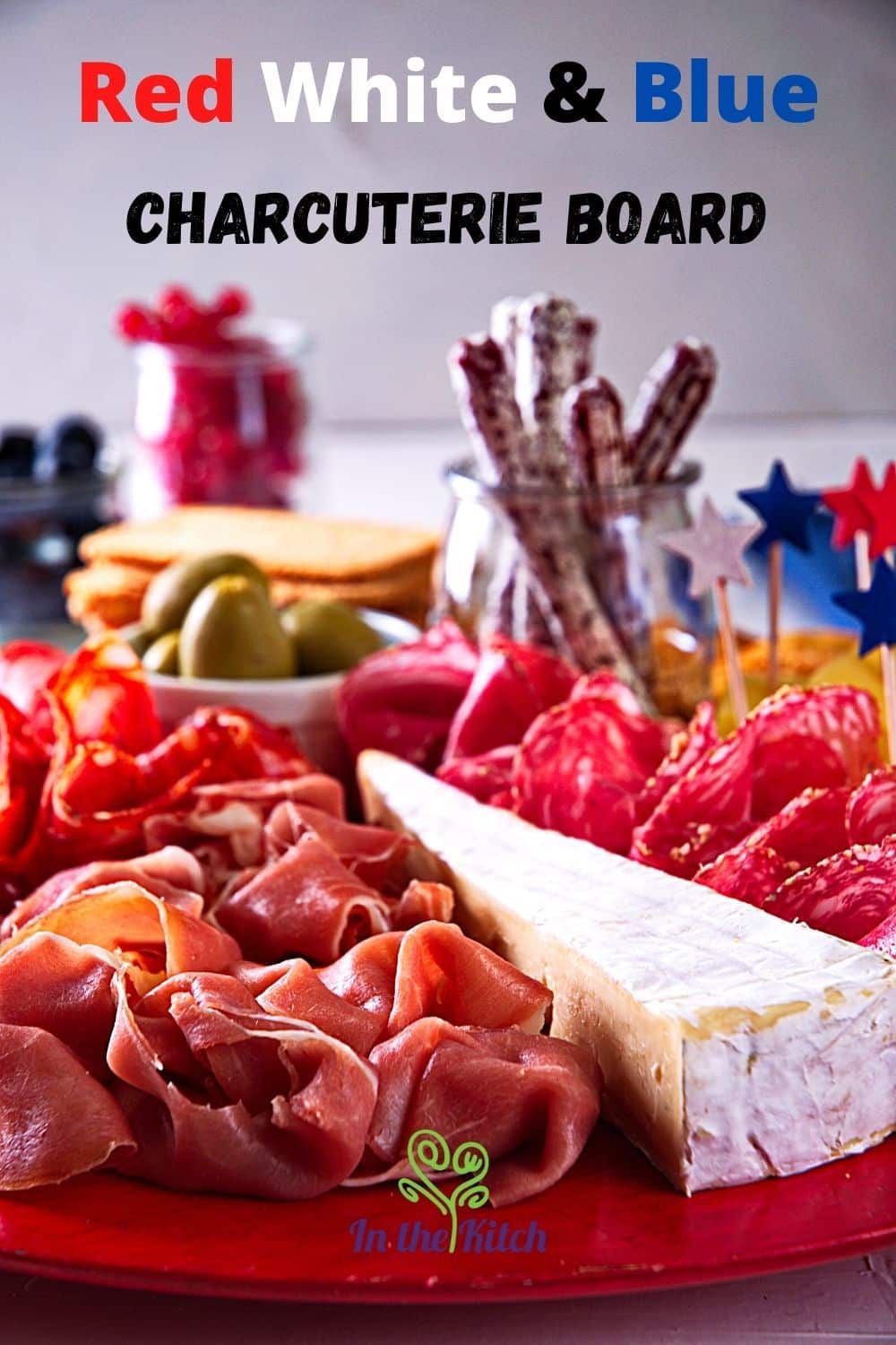4th of July meat and cheese board with text overlay that says 'red white & blue charcuterie board'.