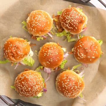 4th of July pulled pork sliders on parchment lined serving tray.