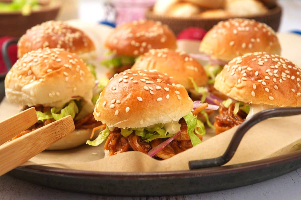 Pulled pork sliders on serving tray.