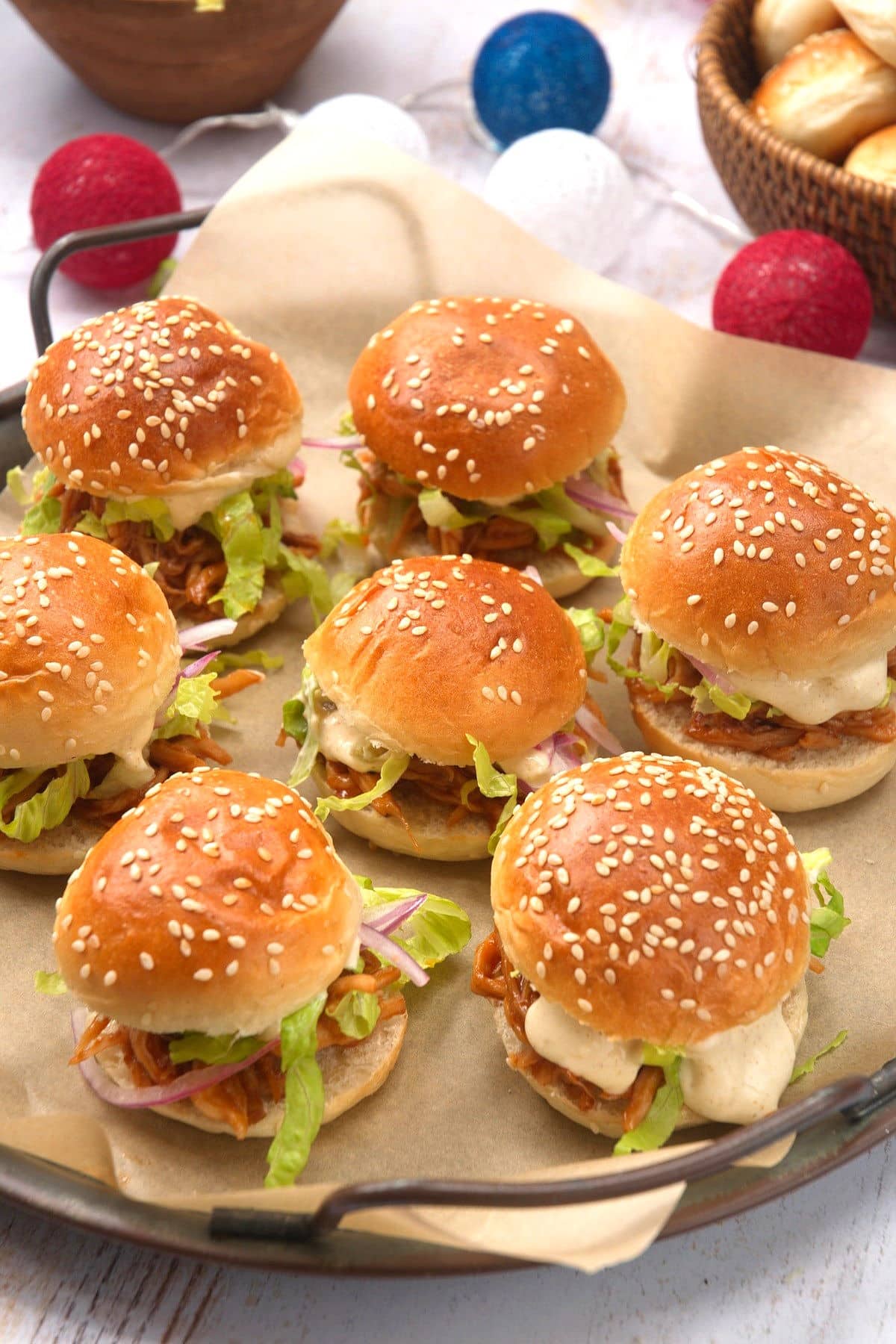 Pulled pork sliders on serving tray with 4th of July decor.