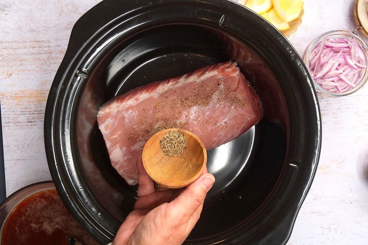 Raw pork loin in slow cooker.