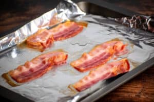Bacon strips on foil lined baking sheet.