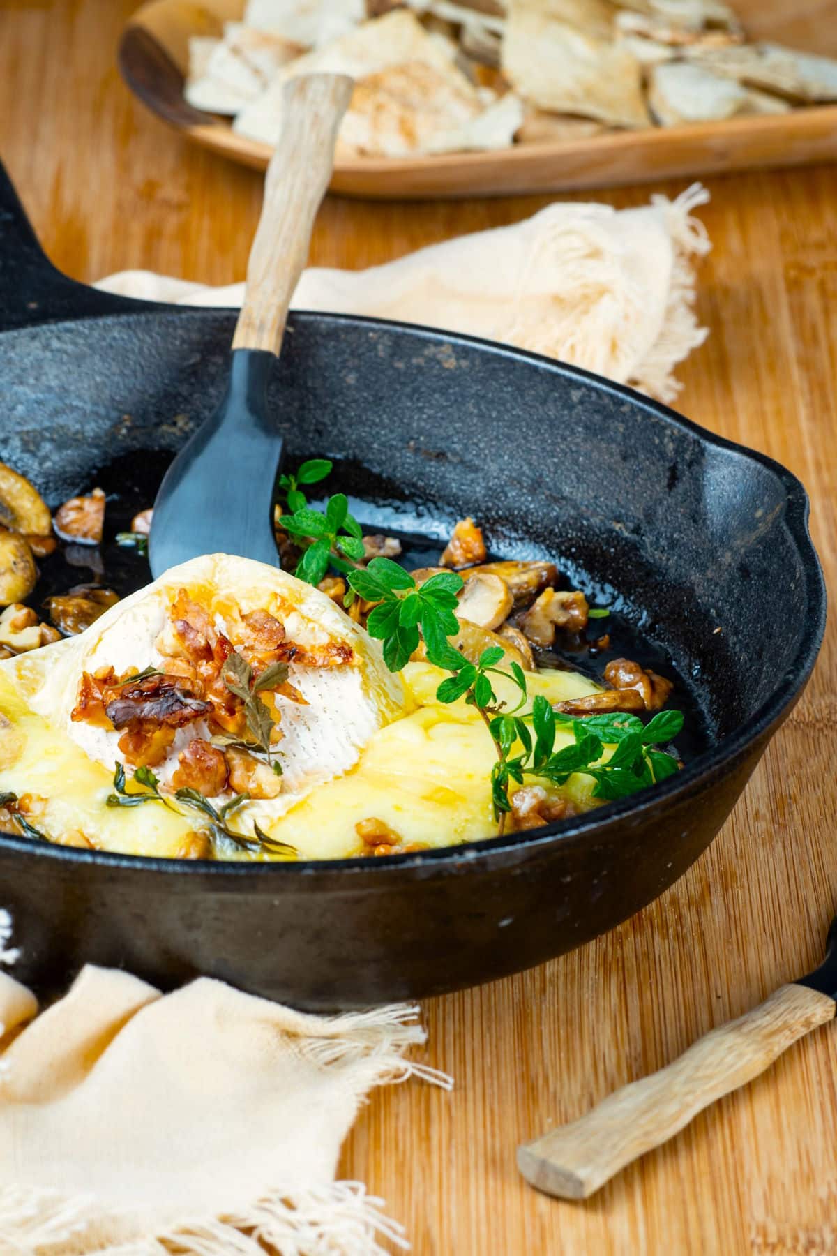 Baked brie in cast iron pan with mushrooms, fresh thyme, walnuts and honey.