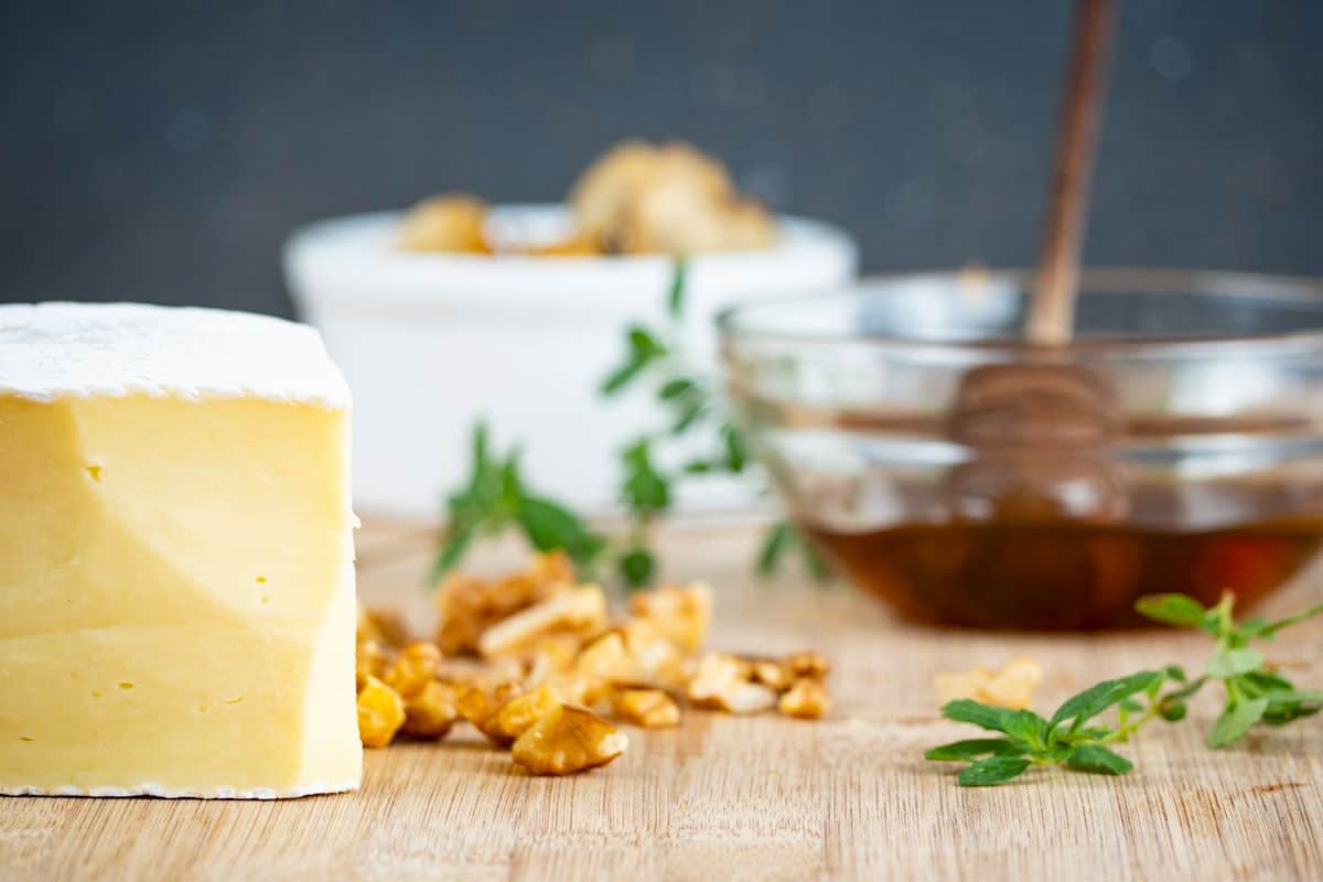 Baked brie ingredients prepped on wooden table.