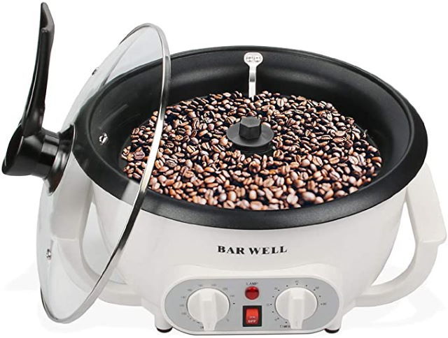 White and black coffee bean roaster machine on white background.