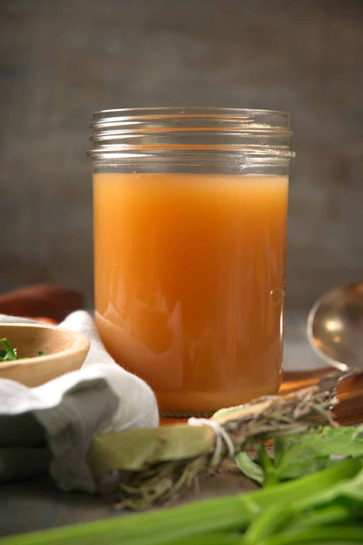 Bison bone broth in a small jar with dark background.