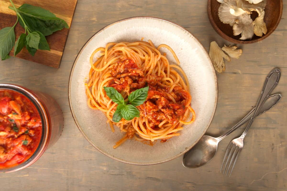 Bison meat sauce over spaghetti in a bowl.