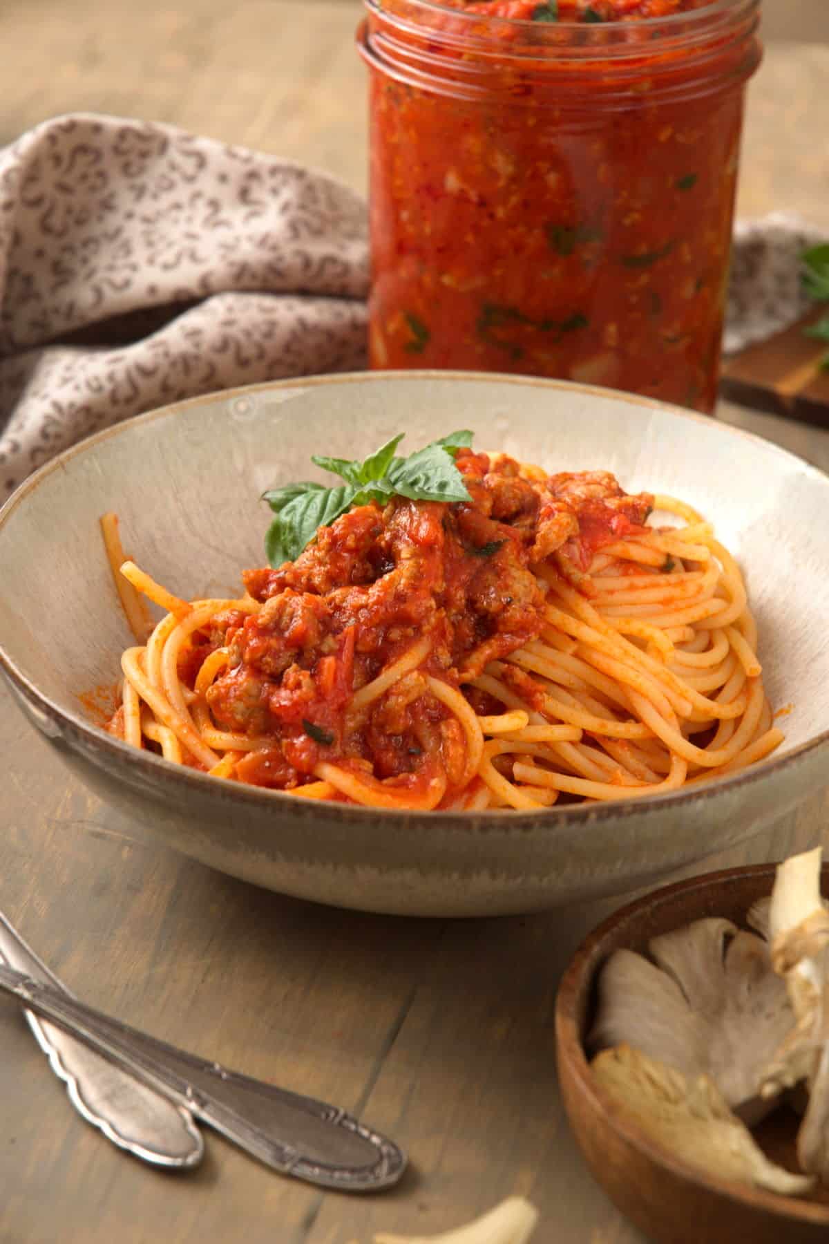 Bison meat sauce over spaghetti in a bowl.