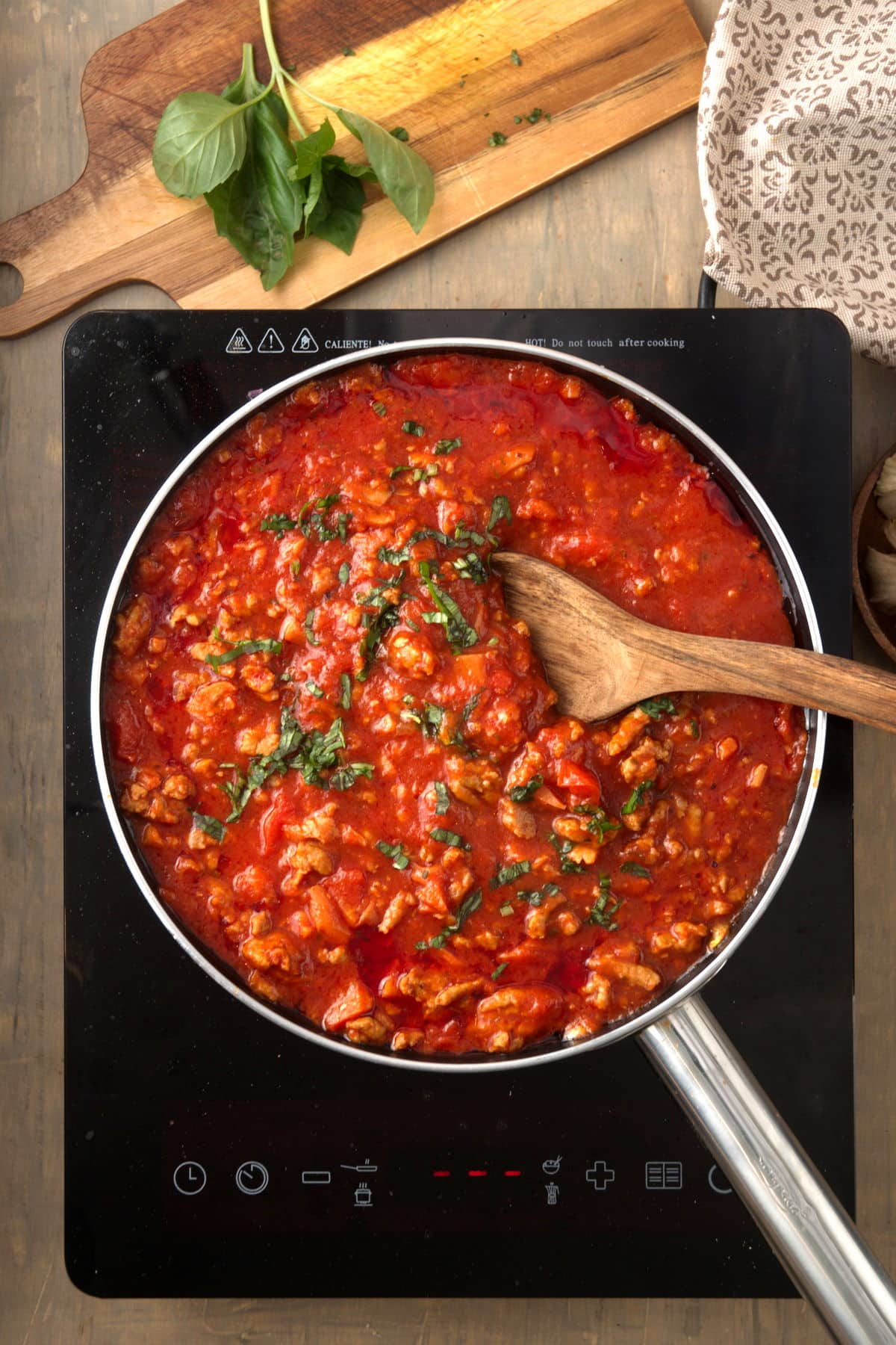 Bison meat sauce in pan on portable cooktop.
