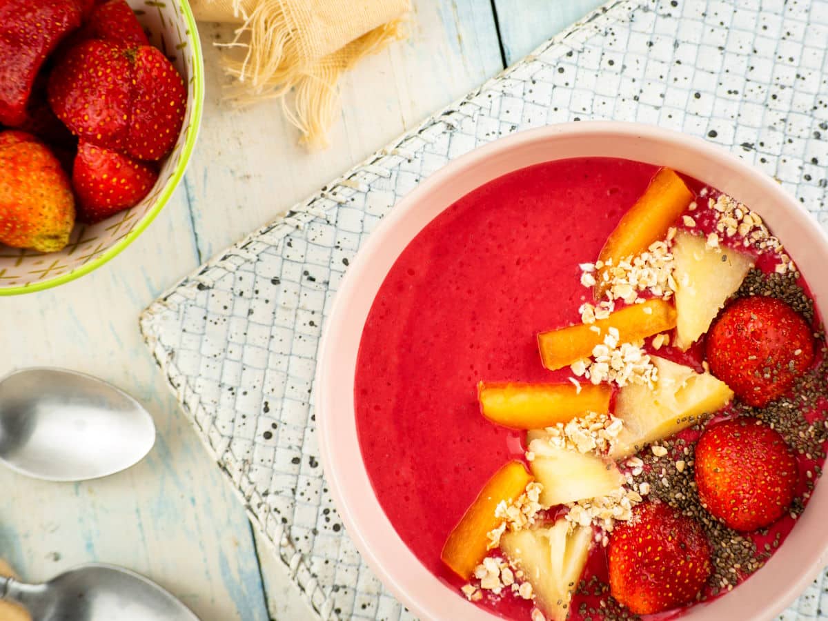Blackberry smoothie in a bowl with spoons on the side.