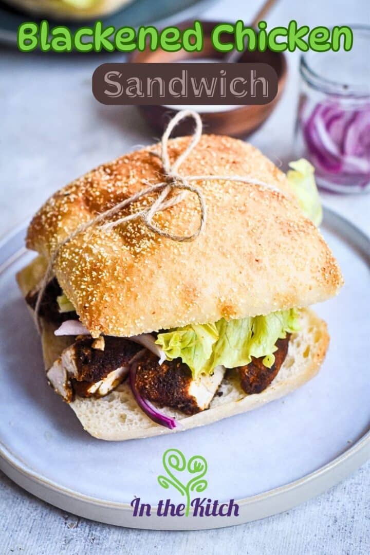 Blackened chicken sandwich on plate with text overlay that says 'blackened chicken sandwich'.
