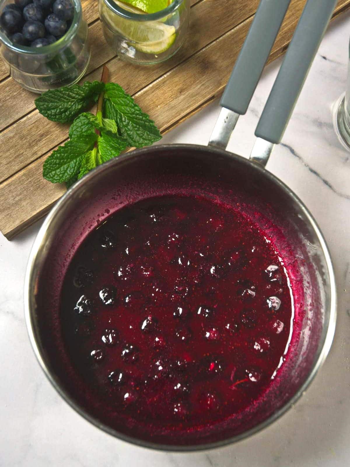 Blueberry-lime sugar syrup in saucepan.