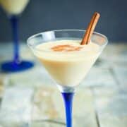 Brandy Alexander cocktail in a martini glass with blue stem.