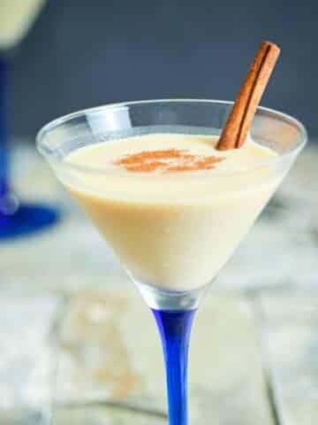Brandy Alexander cocktail in a martini glass with blue stem.