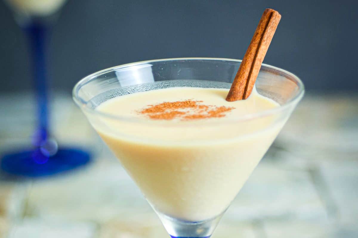 Brandy Alexander cocktail in a martini glass with cinnamon stick.