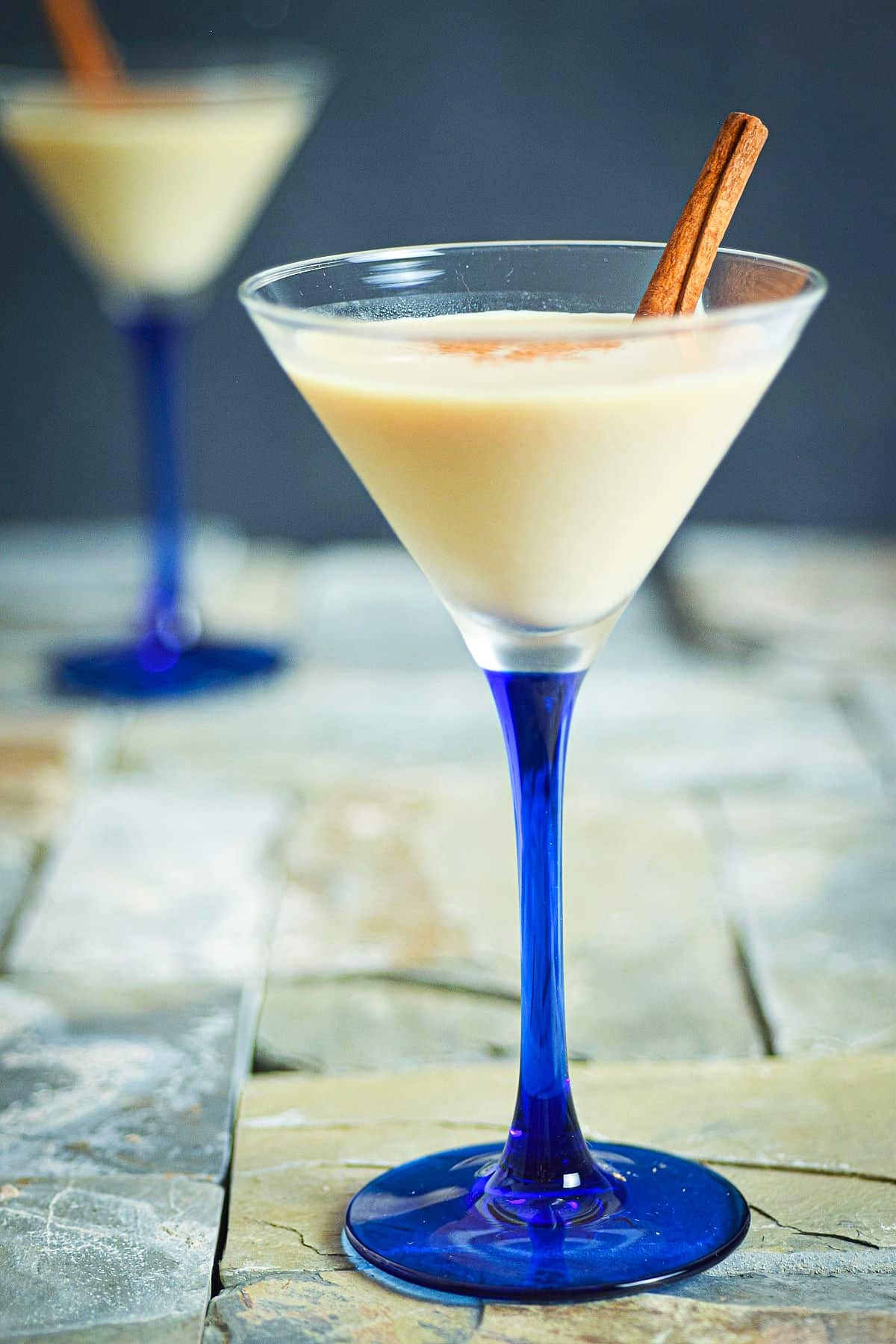 Brandy Alexander cocktail in a martini glass with blue stem.