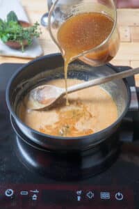 Broth and roux in frying pan.