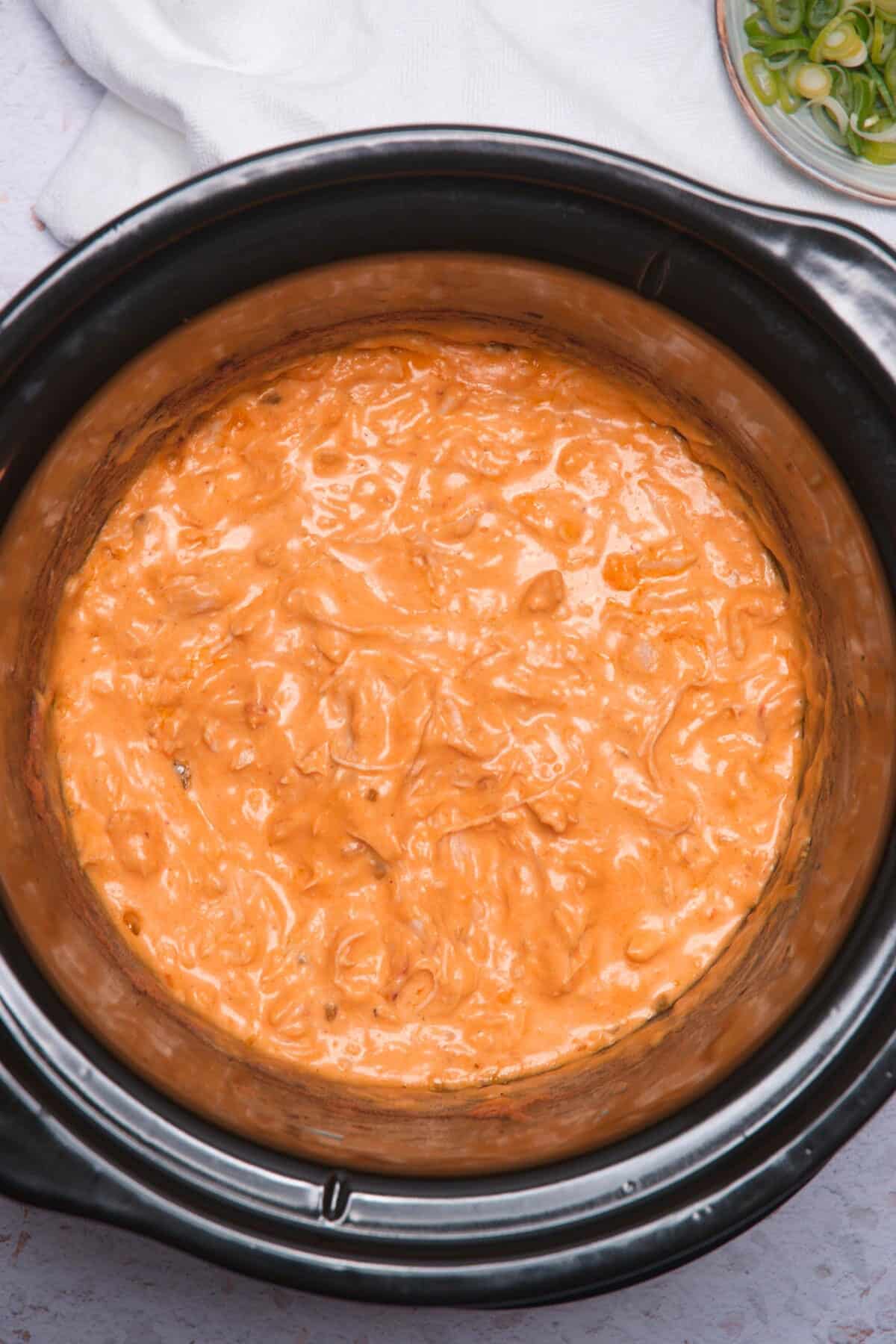Buffalo chicken dip in slow cooker.