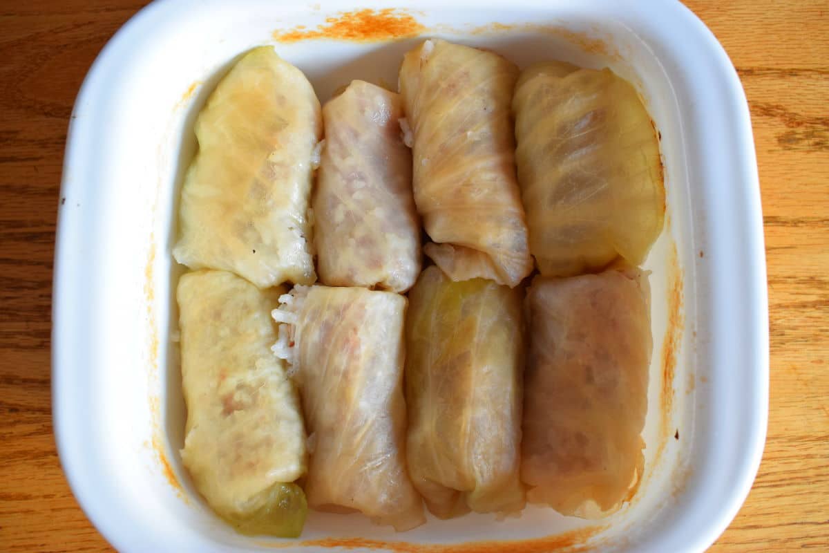 Baked cabbage rolls in casserole dish.