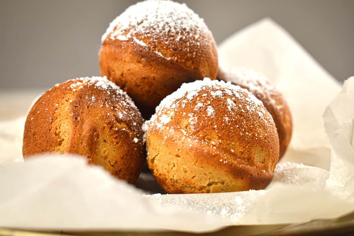 Ginger Bread Cake Pops_2 Gingerbread cake balls on parchment, covered in powdered sugar.