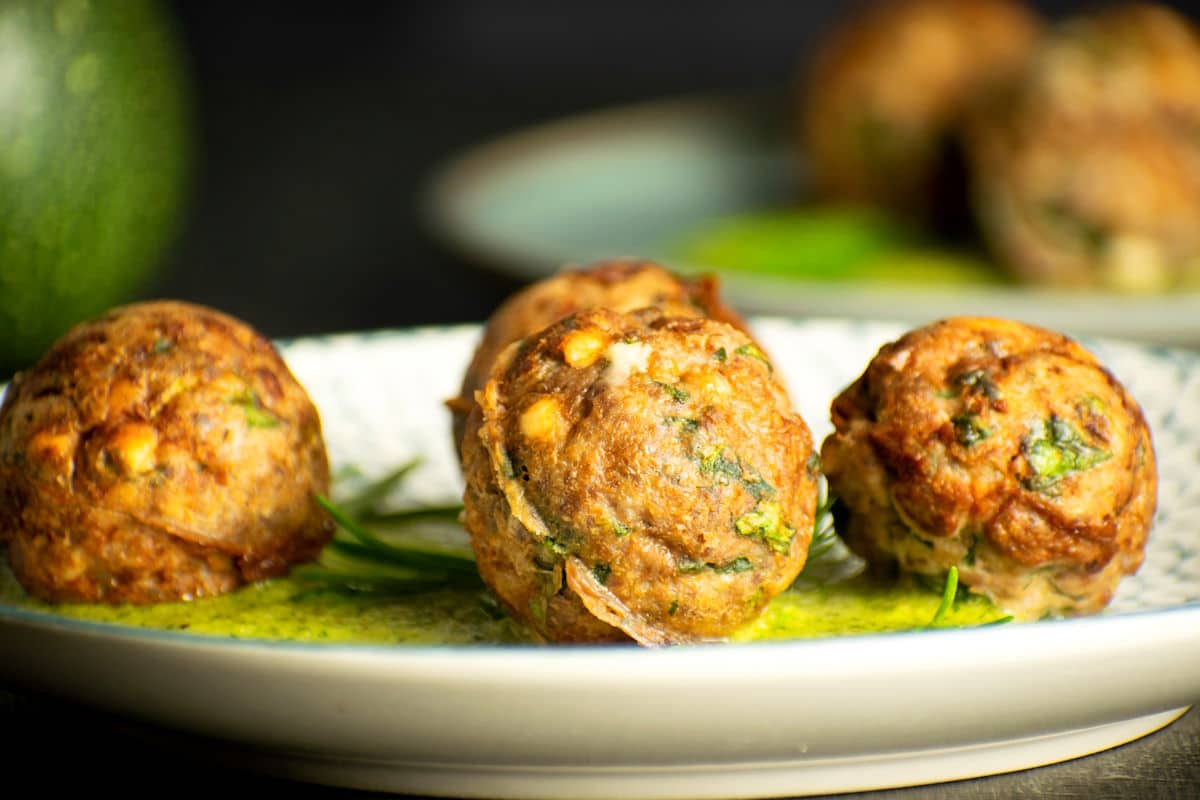 Mediterranean meatballs with dill sauce on plate.