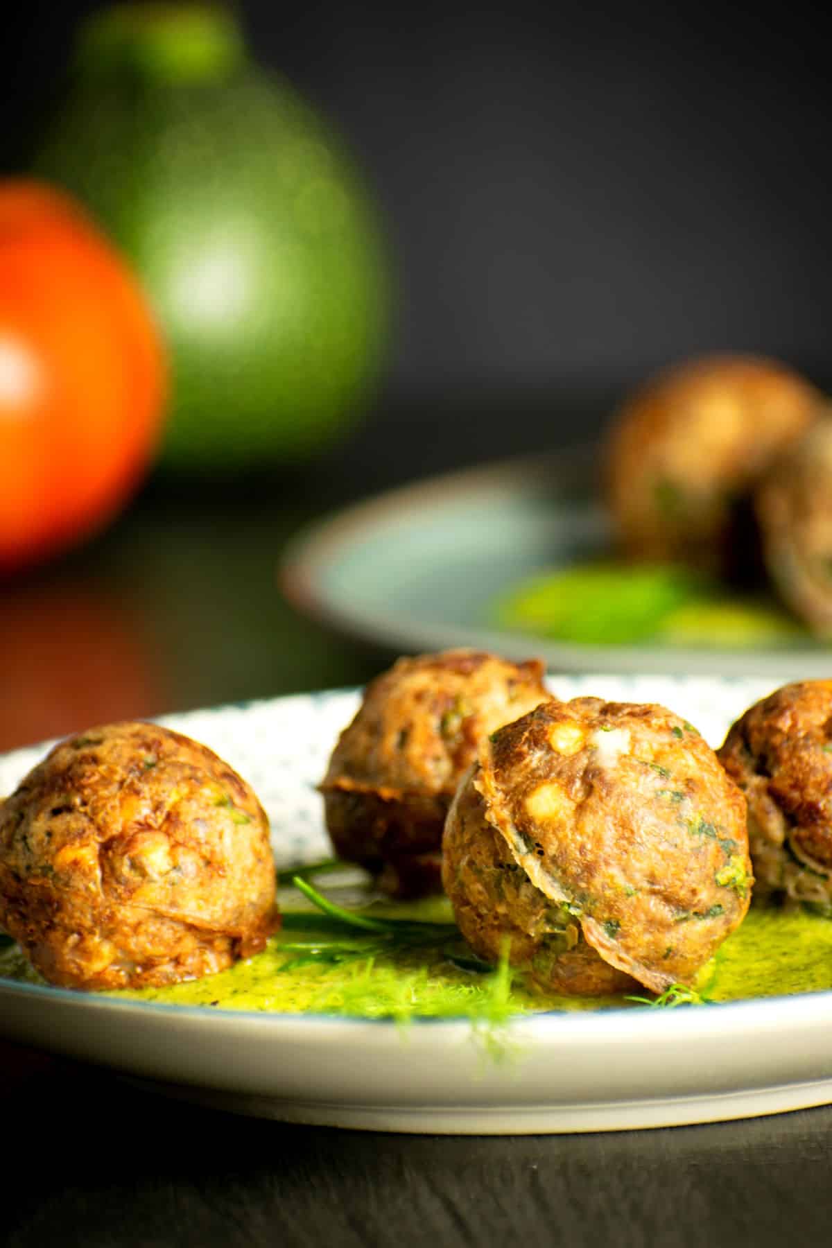 Mediterranean meatballs with dill sauce on plate.