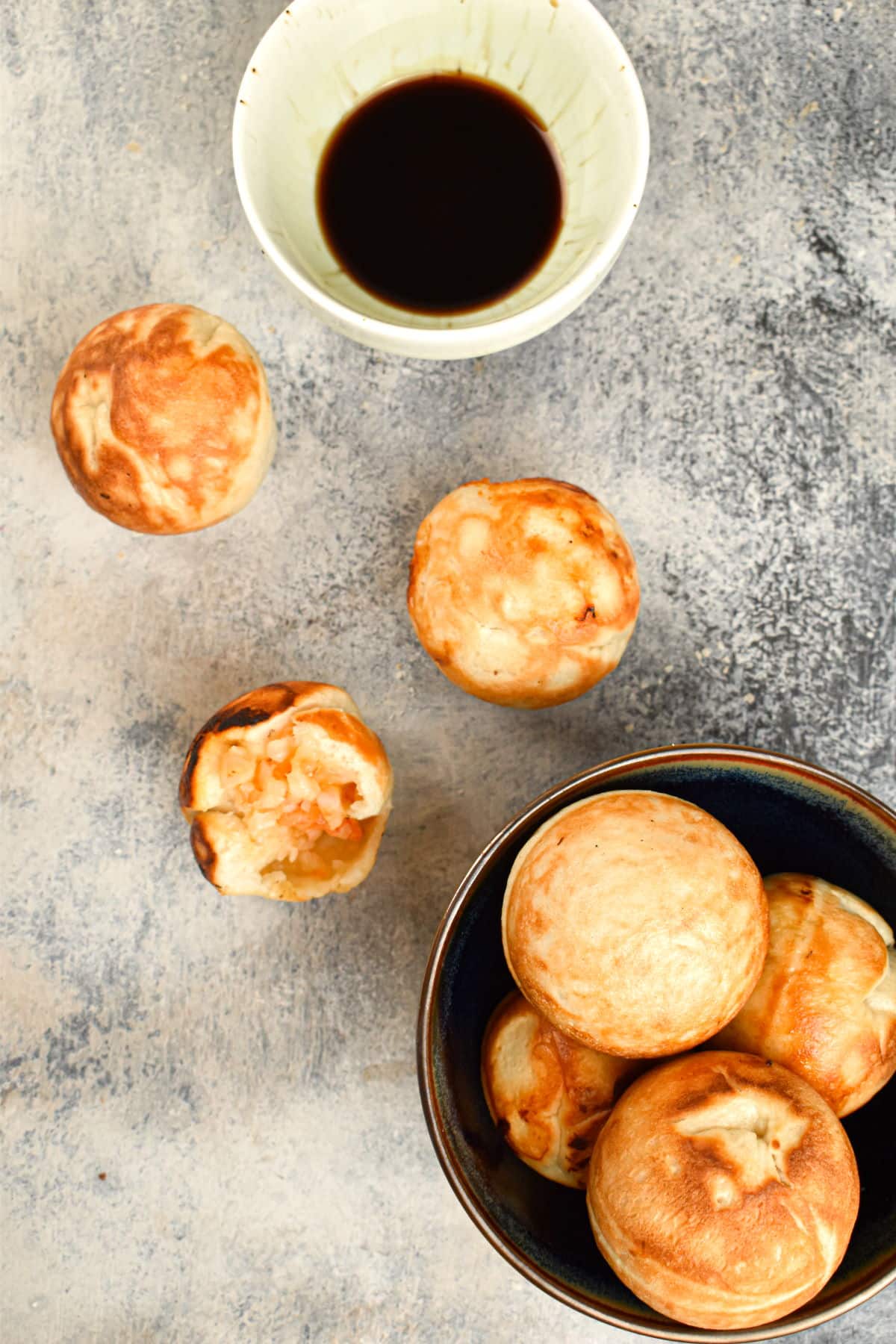 Shrimp balls in a bowl with dipping sauce on the side.