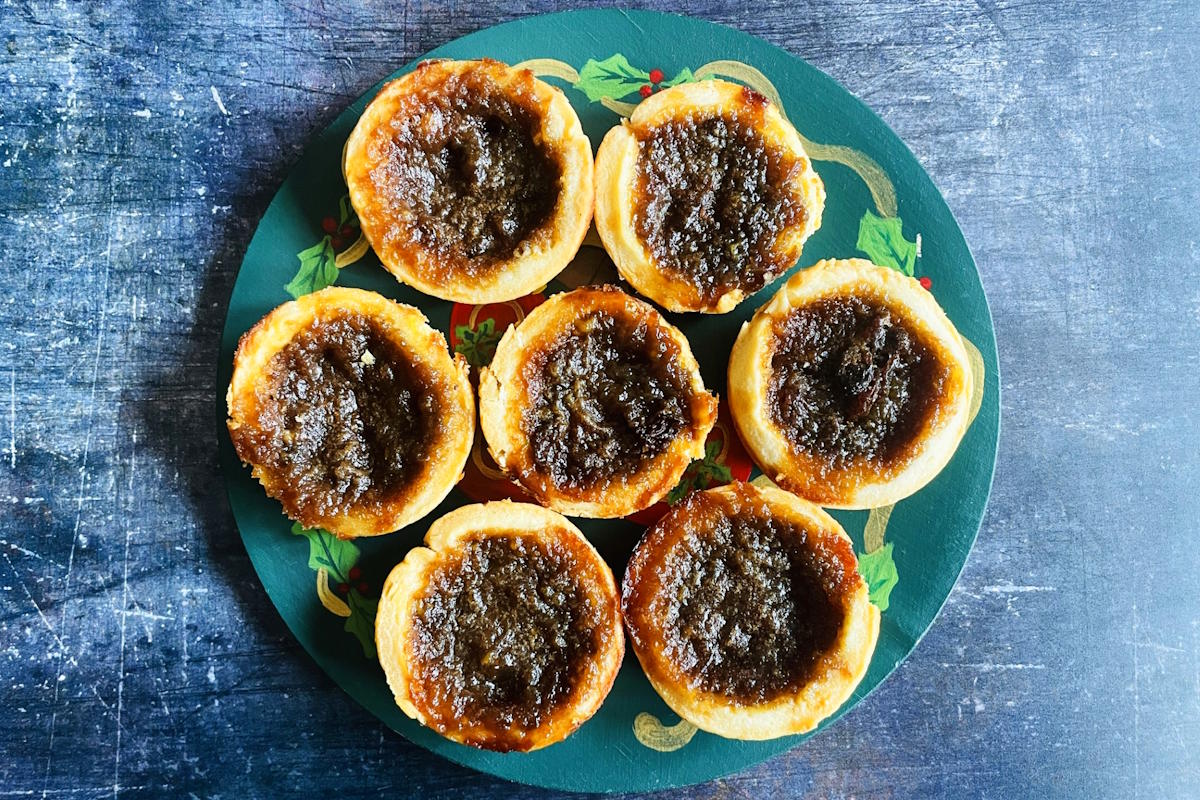 Butter tarts on Christmas themed plate.