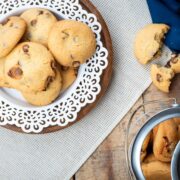 Top view of cookies on a white plate with cookie jar on the side.
