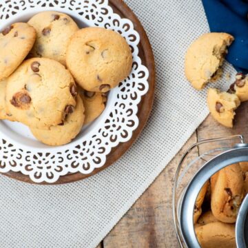 Top view of cookies on a white plate with cookie jar on the side.