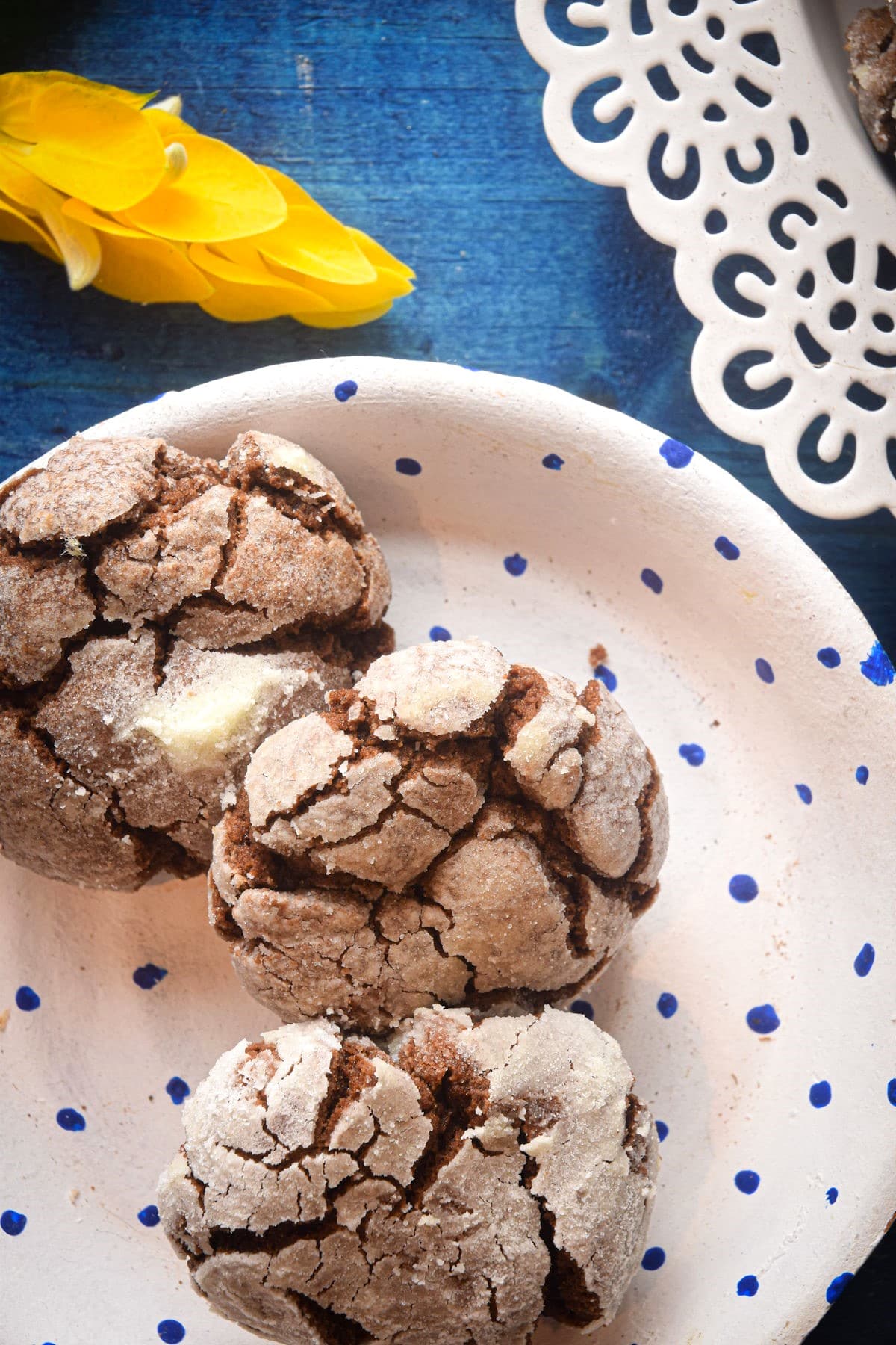Chocolate crinkle cookies on paper plate.